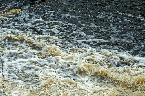 Raging water with foamy sparks