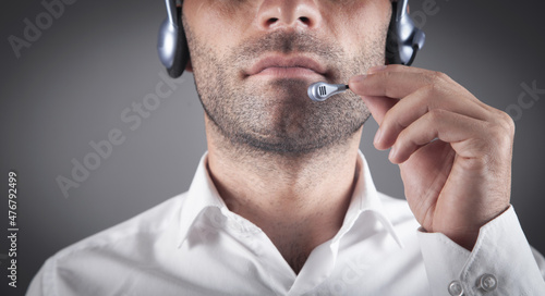 Caucasian customer support operator with headset in office.