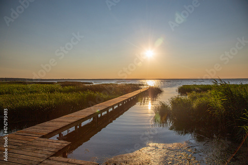 Wooden jetty on the lake during the sunset © Natalia