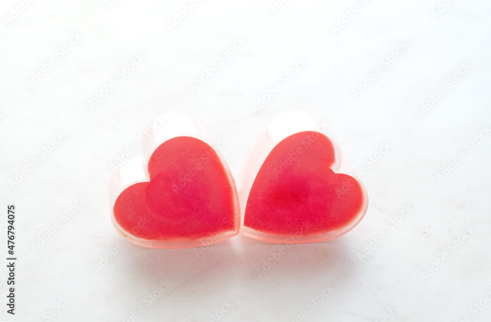 Fototapeta premium Two Valentine romantic hearts on white surface.