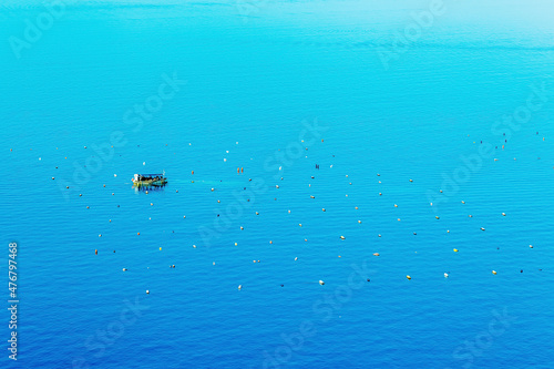 migrants on a ship in the sea. © jozefklopacka