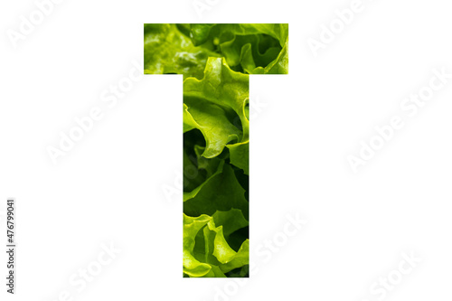 Letter T of the English alphabet made from fresh green lettuce leaves on a white isolated background. Bright alphabet for design