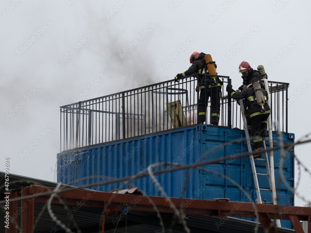 firefighters extinguish a fire in a warehouse