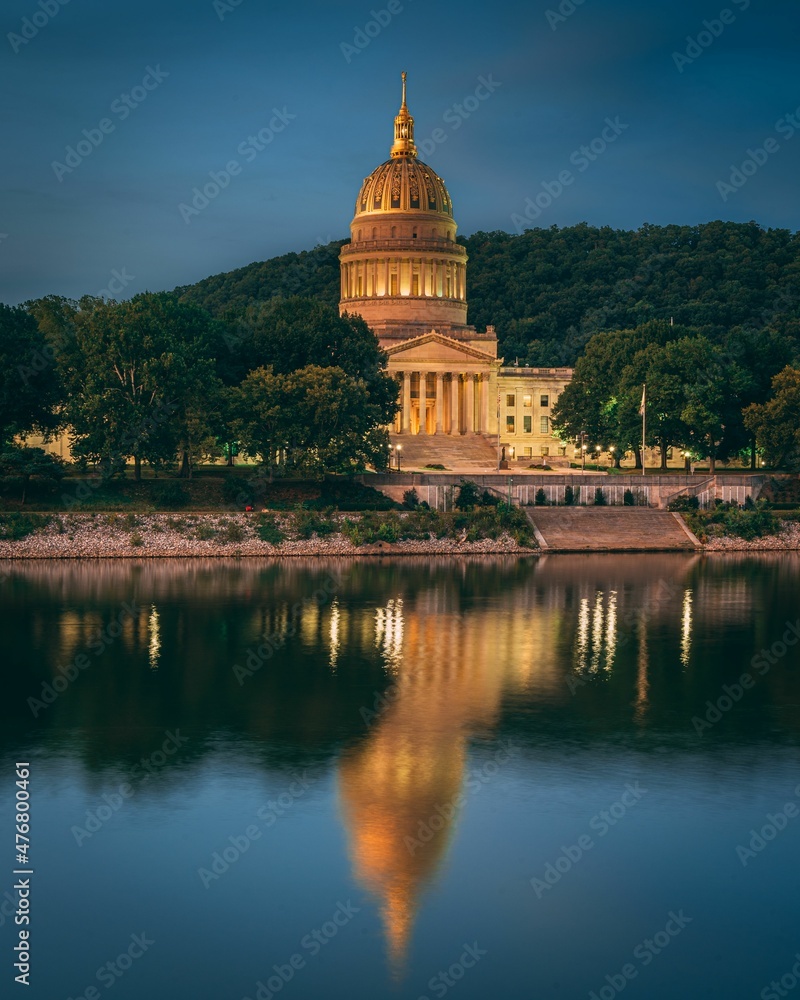 The West Virginia State Capitol and Kanawha River at night, in Charleston, West Virginia