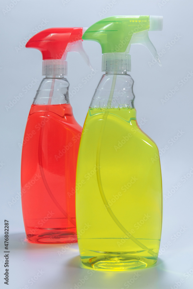 Two containers of cleaning agent - red, green. on a white background Two containers of cleaning agent - red, green. on a white background