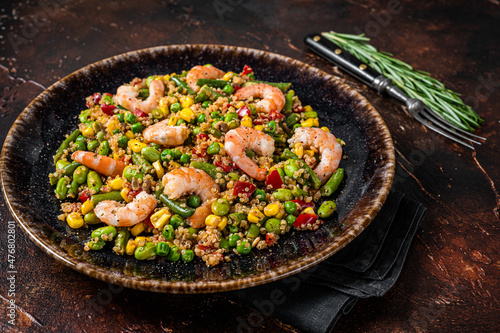 Fresh healthy food - Vegetarian salad with quinoa, vegetables and Shrimps, Prawns. Dark background. Top view