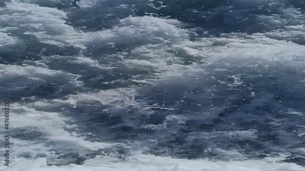 the sea foaming at the back of the ferry with the spin of the propeller the sea foaming at the back of the ferry with the spin of the propeller
