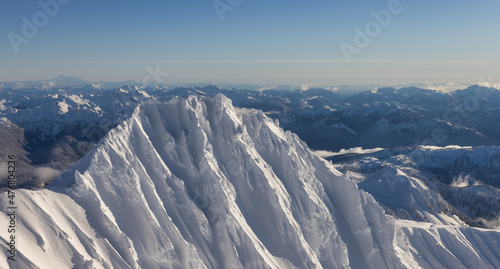 Aerial View of Canadian Mountain covered in snow during sunny winter season. Located near Squamish, North of Vancouver, British Columbia, Canada. Nature Background