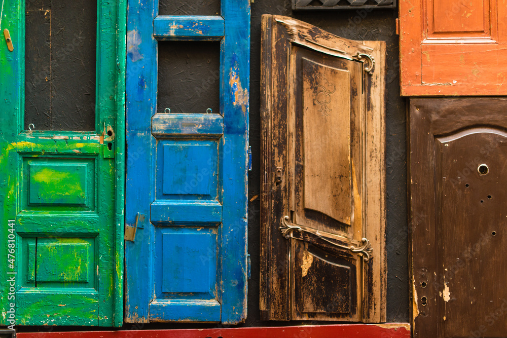 Wooden beautiful colored doors at the old buildings in the small neighborhood. Vintage doors. Stock photo