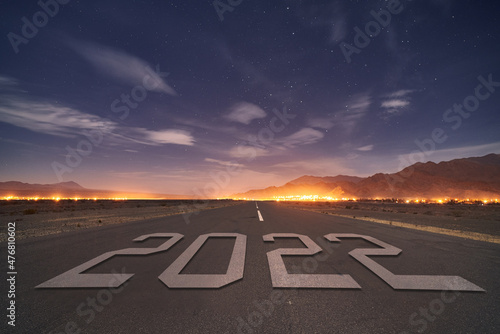 Plane Landing track during night under stars with a city behind during 20222