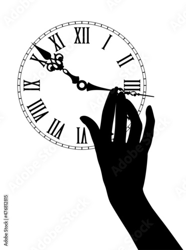 Black silhouette of female hand moves the hour hands on the dial of an antique watch