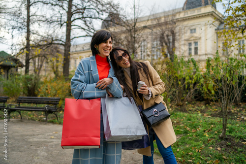 Two beautiful young women with shopping bags walking down the street © DusanJelicic
