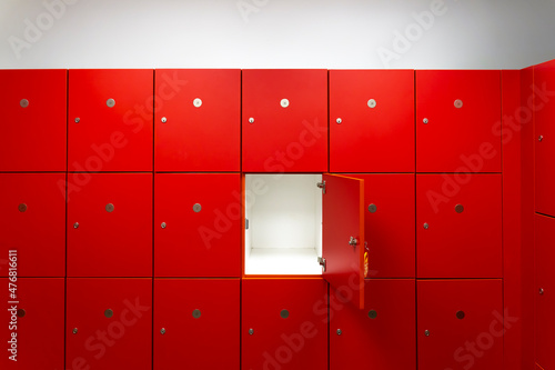Deposit red locker boxes or gym lockers inside of a room with one central opened door