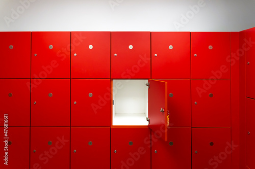 Photos Deposit red locker boxes or gym lockers inside of a room with one central opened