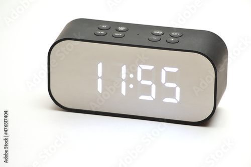 Clock with a time of 11 hours 55 minutes on a white background