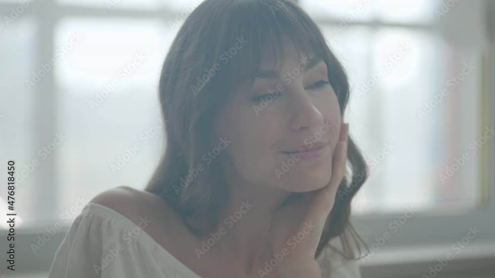 Feminine young woman with vitiligo touching skin, admiring mirror reflection Feminine young woman with vitiligo touching skin, admiring mirror reflection