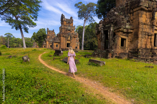 A western tourist in the ancient buildings in Angkor Thom, Cambodia