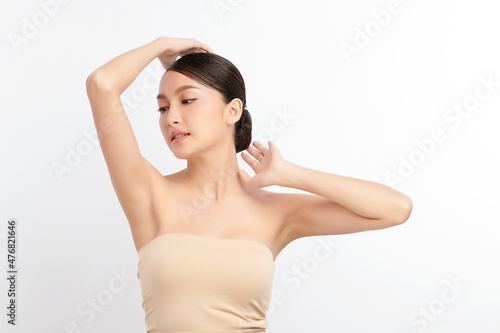 Beautiful Young Asian woman lifting hands up to show off clean and hygienic armpits or underarms on white background, Smooth armpit cleanliness and protection concept