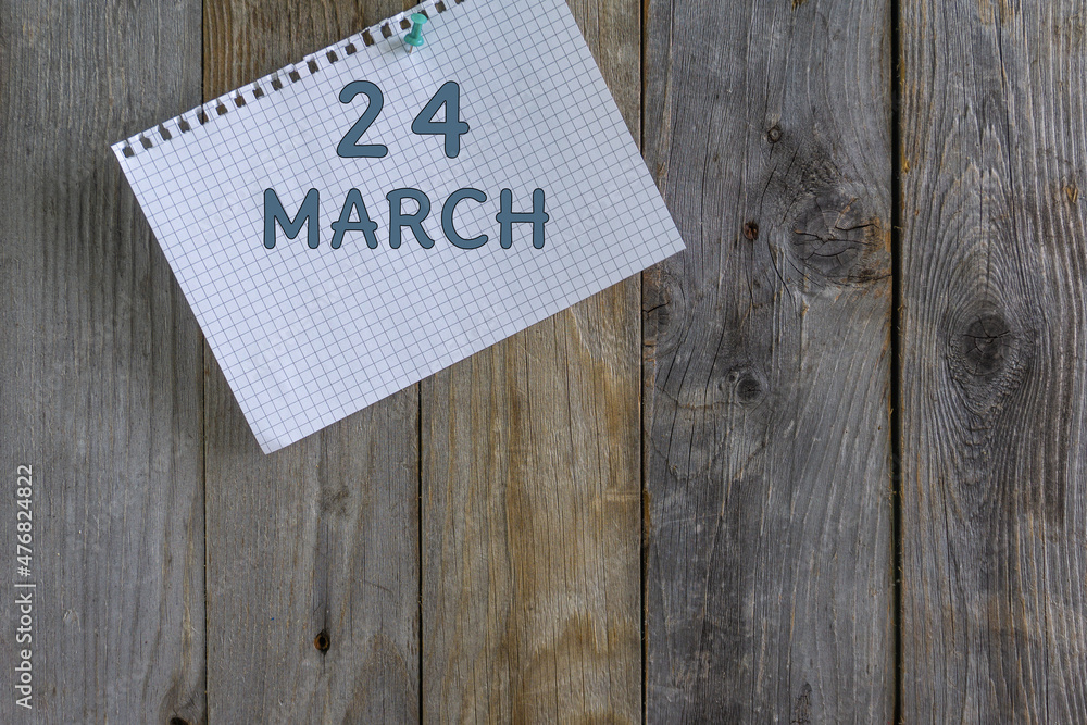 Day of month.A white sheet of checkered paper from a notebook with a date is pinned with a stationery button to a wooden background. Day of month.A white sheet of checkered paper from a notebook with a date is pinned with a stationery button to a wooden background.