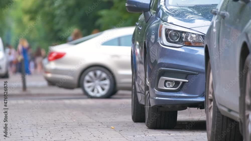 City traffic with cars parked in line on street side City traffic with cars parked in line on street side