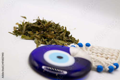 Scattered dried ivan tea on a white blurred background with an amulet photo