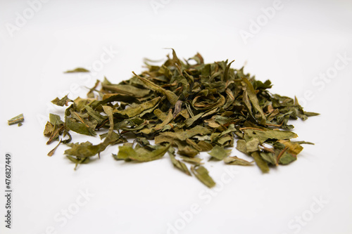 Fotografija Scattered dried ivan tea on a white blurred background with an amulet