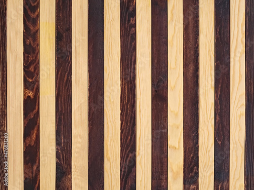 Background of alternating dark and light wooden planks. Seamless striped pattern.