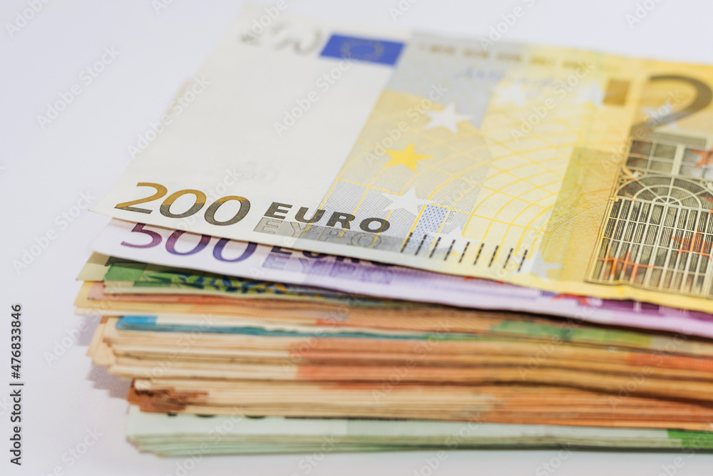 Close up of euro banknotes. Euro stack on white. A bundle of money. Close up of euro banknotes. Euro stack on white. A bundle of money.