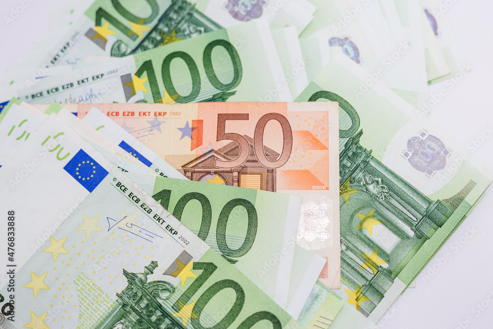 Close up of euro banknotes. 50 euro among 100 euro banknotes. Euro banknotes as a background. Close up of euro banknotes. 50 euro among 100 euro banknotes. Euro banknotes as a background.