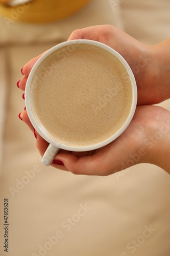 hand holding a cup