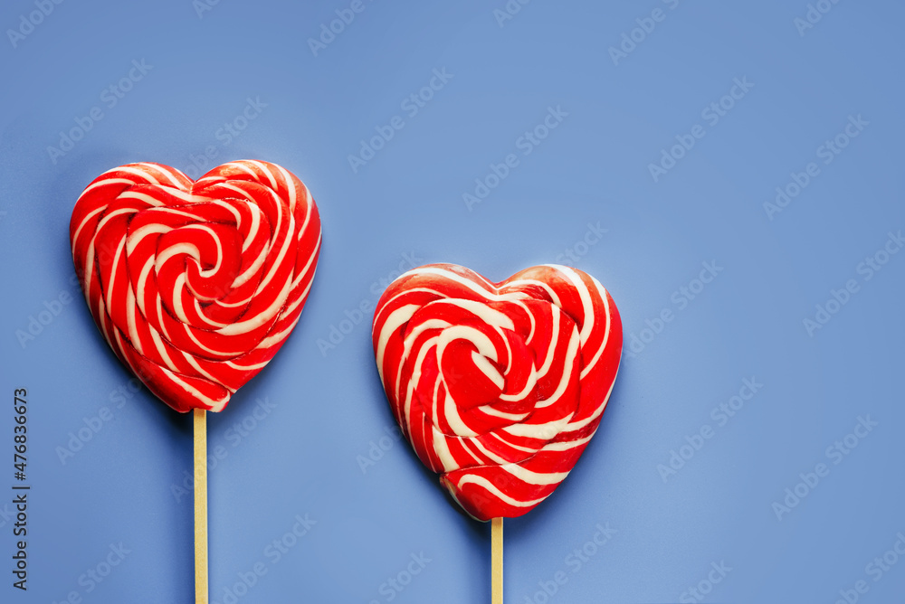 Red heart lollipops on purple background love and Valentine day background