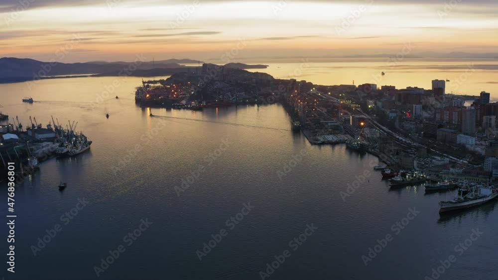 Drone view of the cargo terminal with port cranes at sunset Drone view of the cargo terminal with port cranes at sunset