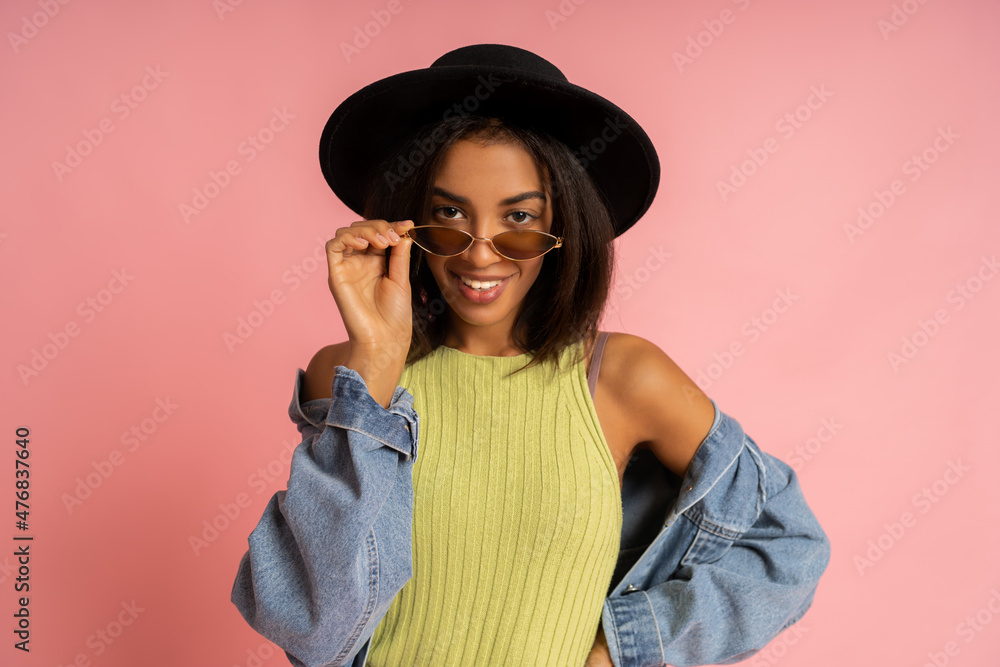Close up portrait of Nice smiling stylish woman in spring outfit posing over pink backgrond in studio. Close up portrait of Nice smiling stylish woman in spring outfit posing over pink backgrond in studio.