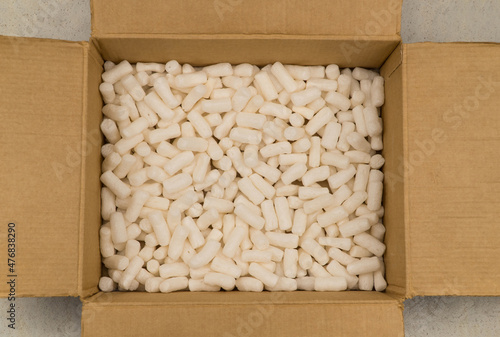 Empty cardboard box with styrofoam filler for safe packaging. Top view