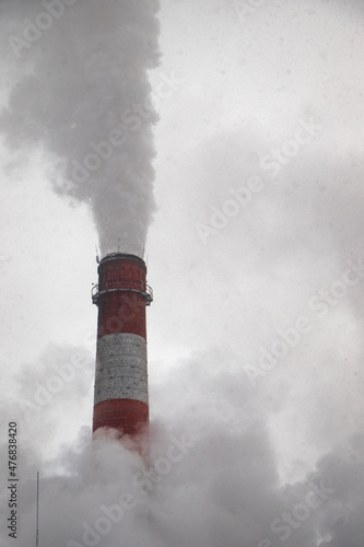 high pollution chimney from coal power plant produsing electricity
