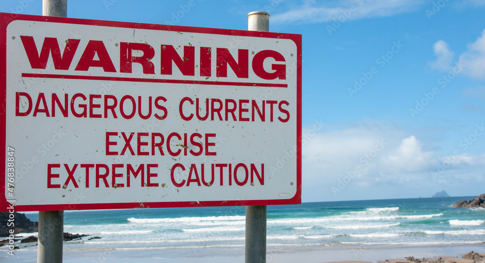 Warning sign on the beach - Strong currents - do not swim Warning sign on the beach - Strong currents - do not swim