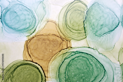 Abstract ocher green circles watercolor background. orange brown paint stains and spots in water, fluid liquid art wallpaper, autumn colors mix
