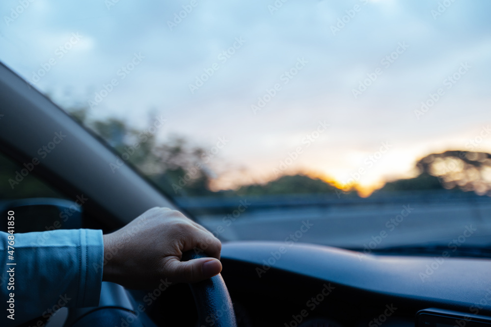 People driving car on sunrise city road . People driving car on sunrise city road .