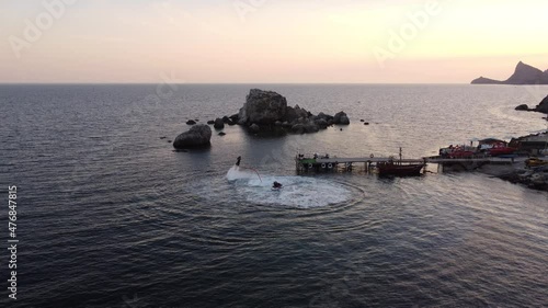 two extremals is using flyboards on Black sea in summer day in Crimea. photo