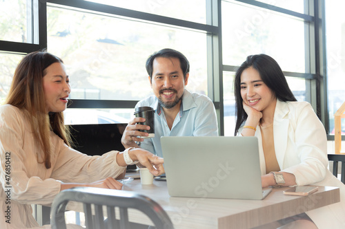 Relaxing together time. Three happy friends or Group of friends in cafe talking and laughing in coffee shop. On line working and enjoying coffee together.