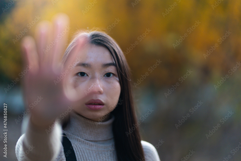 Asian young woman showing stop gesture with hands Asian young woman showing stop gesture with hands