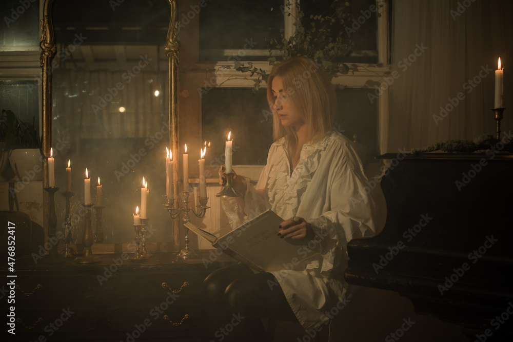 Woman with a candles for fate prediction, details of witch rituals, occultism concept