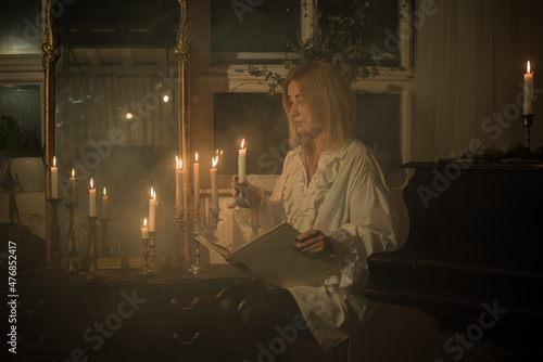 Woman with a candles for fate prediction, details of witch rituals, occultism concept