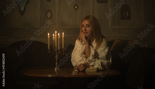 Woman with a candles for fate prediction  details of witch rituals  occultism concept