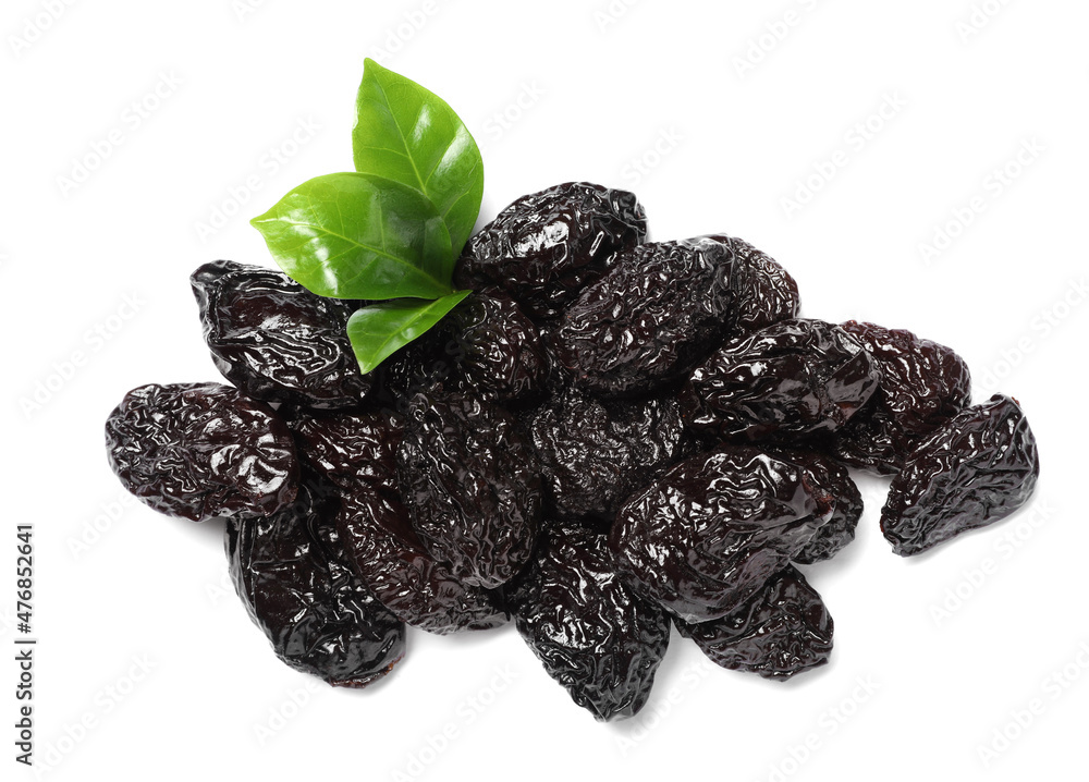 Heap of sweet dried prunes and green leaves on white background Heap of sweet dried prunes and green leaves on white background