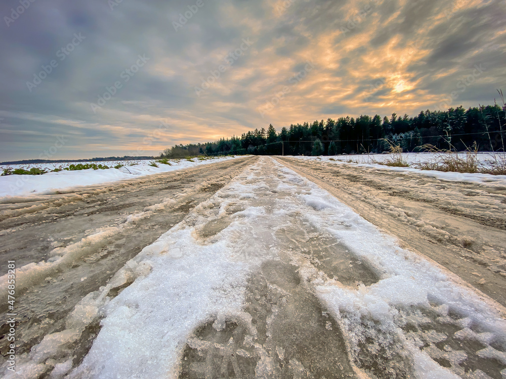 Icy Road in Bavaria with cloudy sunset sky Icy Road in Bavaria with cloudy sunset sky