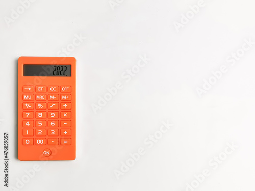 Orange calculator isolated on white background with copy space.
