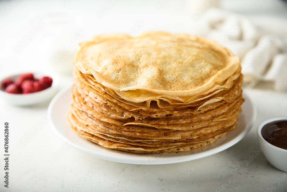 Traditional homemade crepes on a white plate Traditional homemade crepes on a white plate