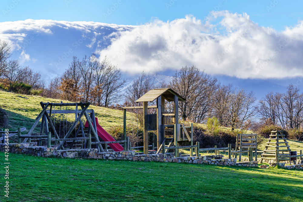 Playground for children to play outside next to the snow-capped mountains. Riaza, Segovia. Playground for children to play outside next to the snow-capped mountains. Riaza, Segovia.