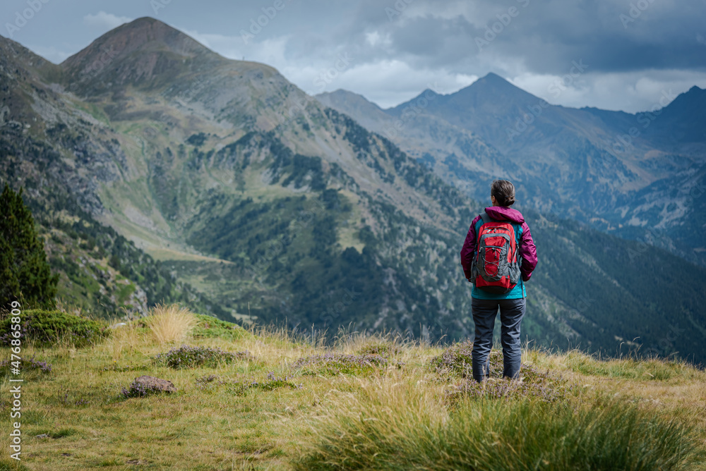 Young hiker enjoy view into the mountains. Young hiker enjoy view into the mountains.